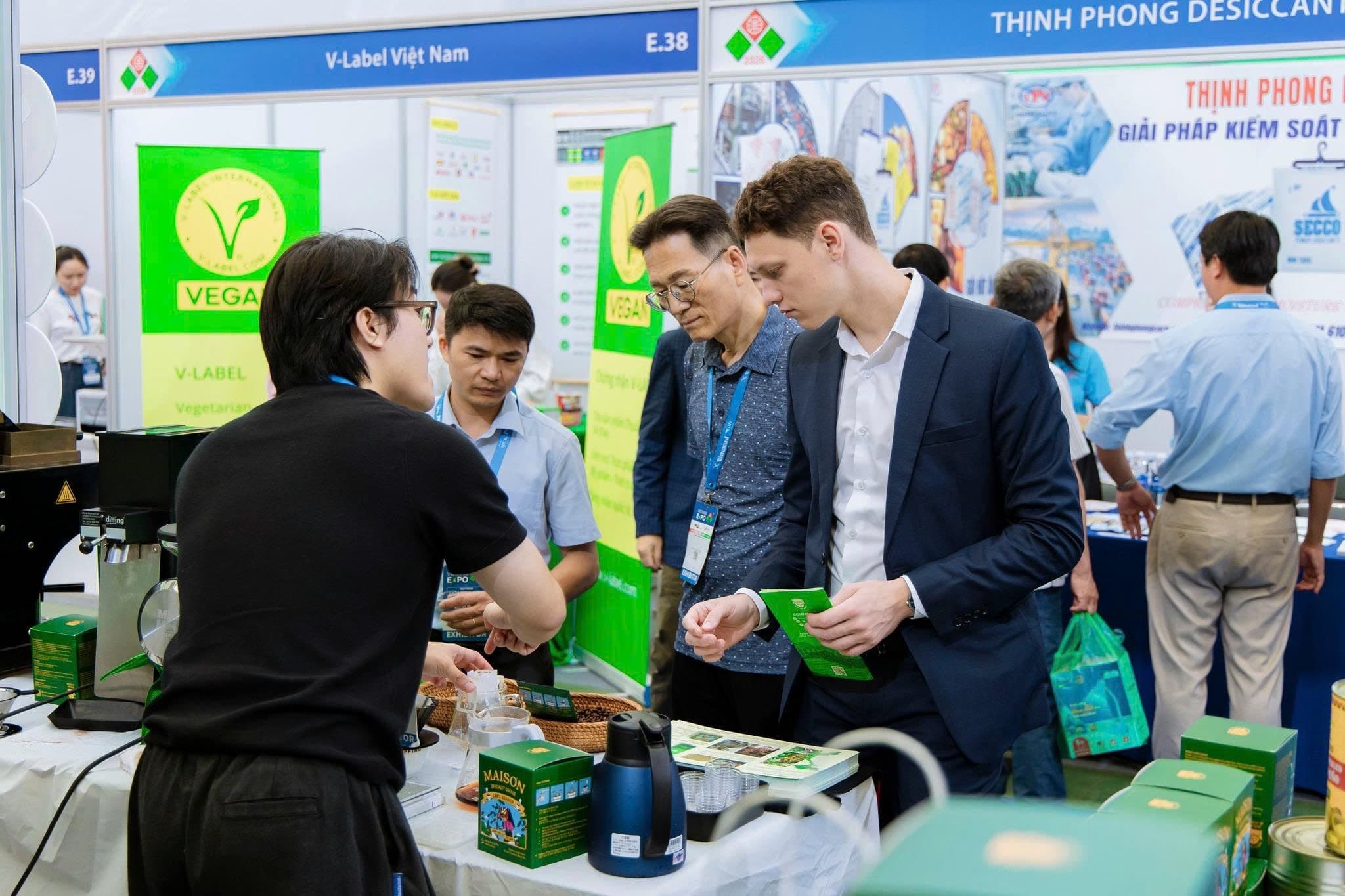 Nhân viên Maison Coffee pha cà phê cho khách tại lối đi đông đúc của hội chợ